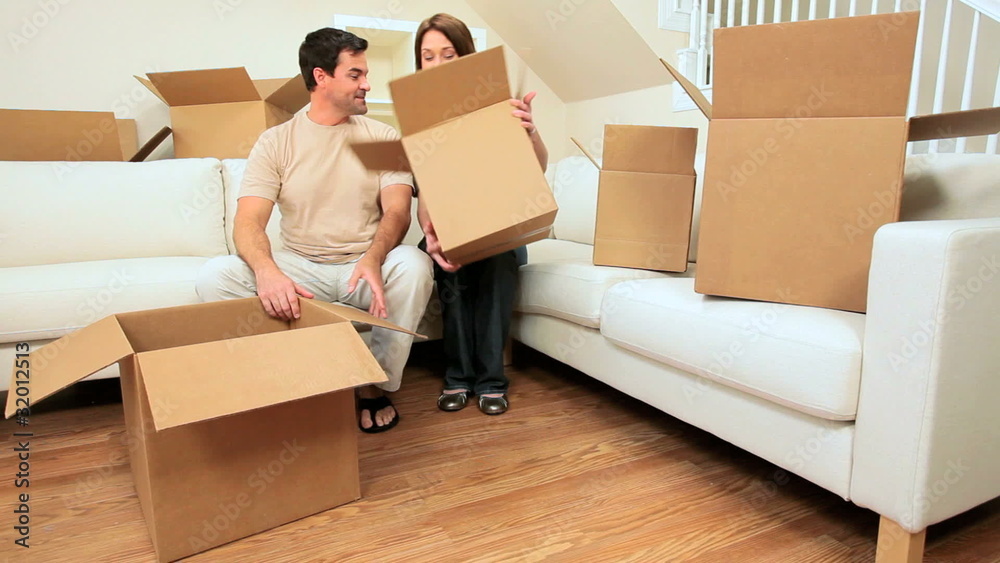 Attractive Couple Surrounded by Moving Boxes Attractive Couple Surrounded by Moving Boxes