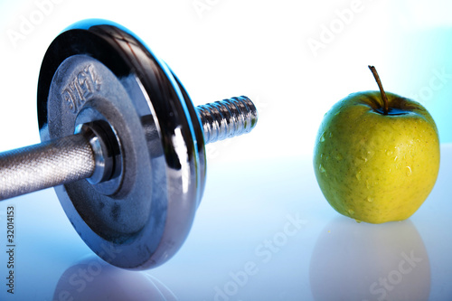 dumbell and a green apple