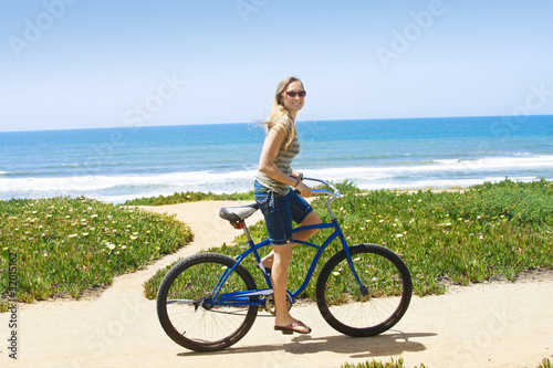Woman on a Bicycle Ride along the beach