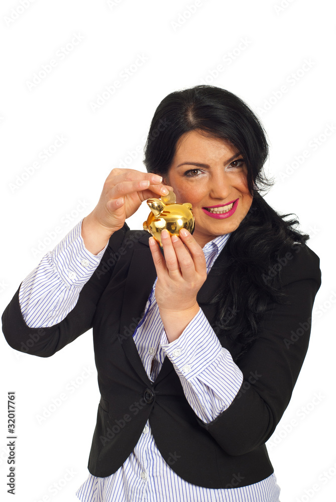 Happy woman put coin in piggy bank Happy woman put coin in piggy bank