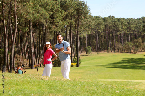 Couple playing golf on a sunny day