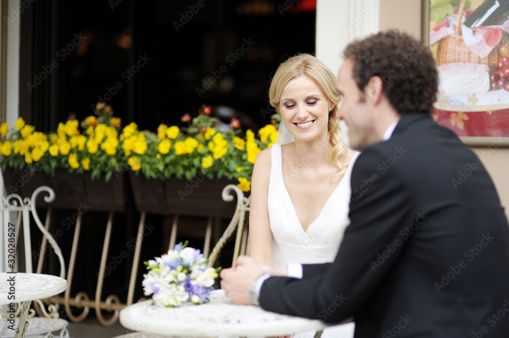 Bride and groom drinking coffee at an outdoor cafe Bride and groom drinking coffee at an outdoor cafe