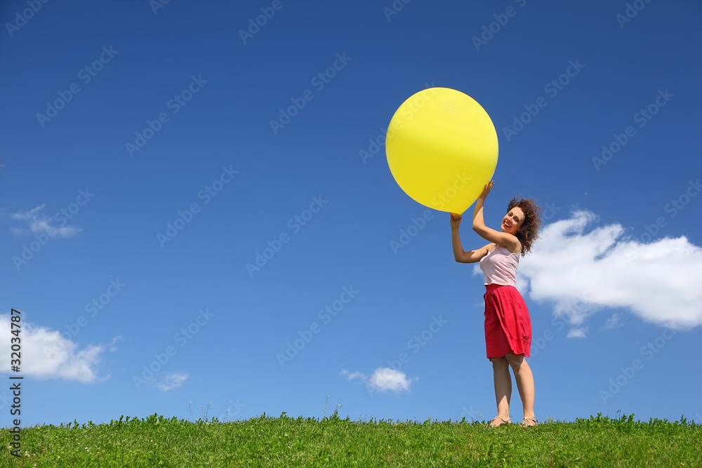 Woman holds large inflatable ball in hands on wind Woman holds large inflatable ball in hands on wind