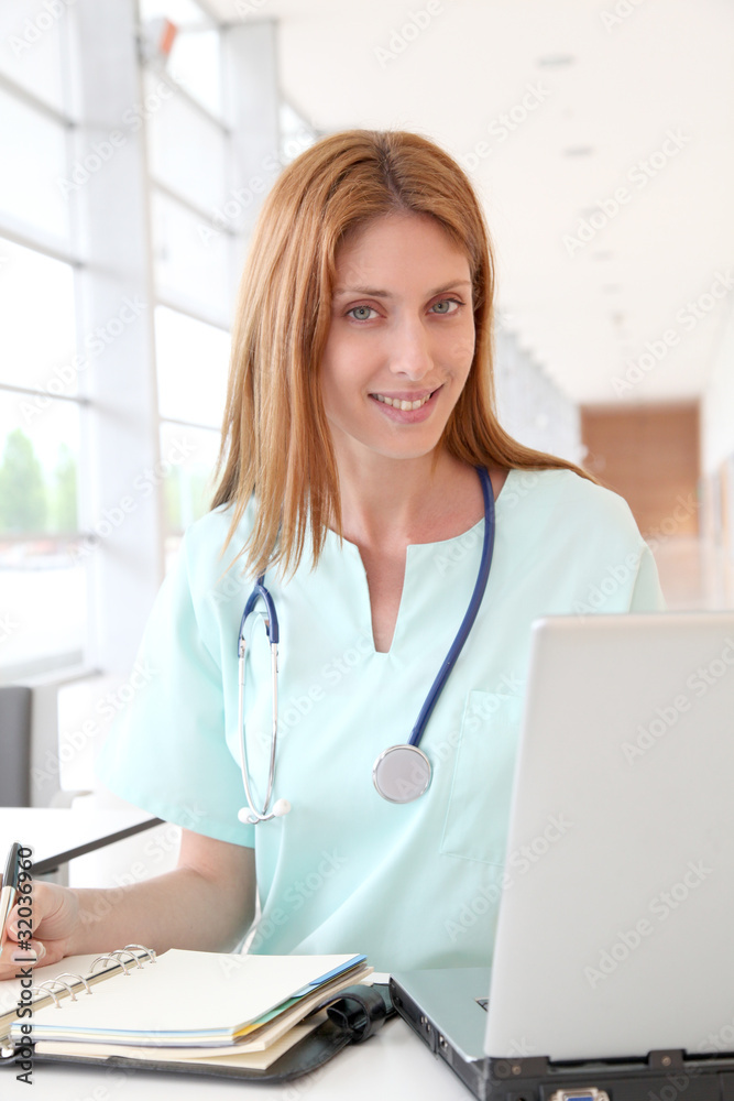 Nurse working on laptop computer in hospital Nurse working on laptop computer in hospital