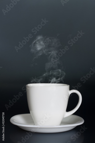 white cup with hot liquid and steam