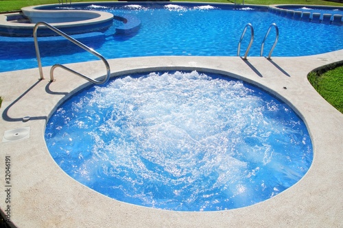blue jet spa pool in green grass garden