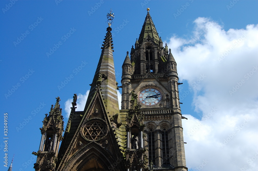 Obraz premium A view of the imposing Gothic Manchester Town Hall In St Peter’s Square with a background of blue sky in Manchester The UK