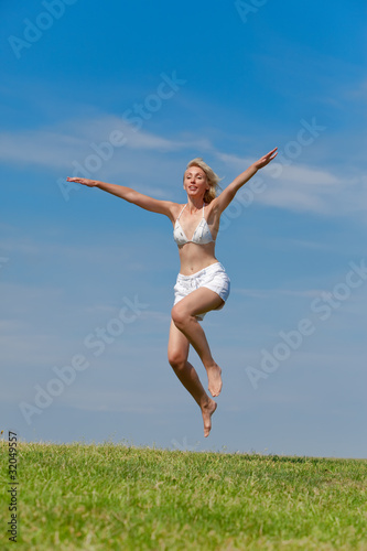 The happy young woman jumps in the field © Konstantin Kulikov