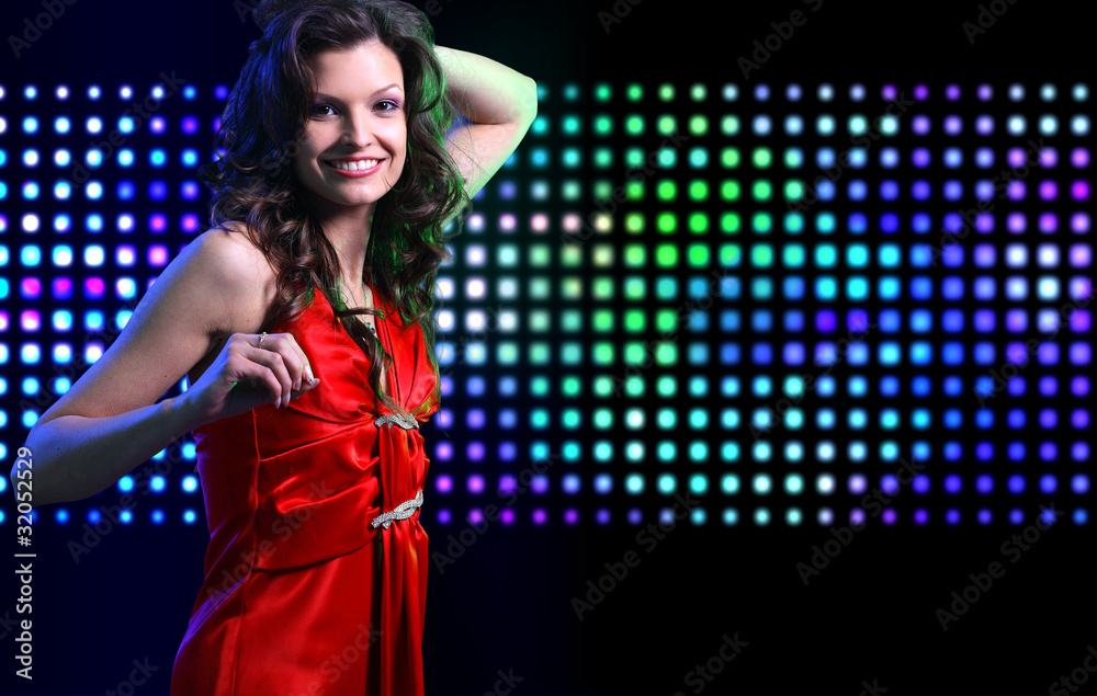Naklejka premium Beautiful young woman dancing in the nightclub