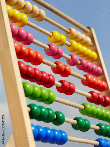 Coloured children abacus in front of blue sky