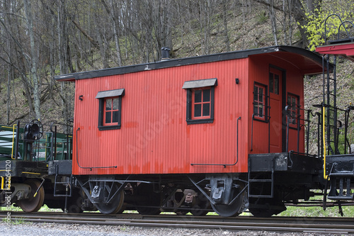 Canvas Print red caboose on a train track