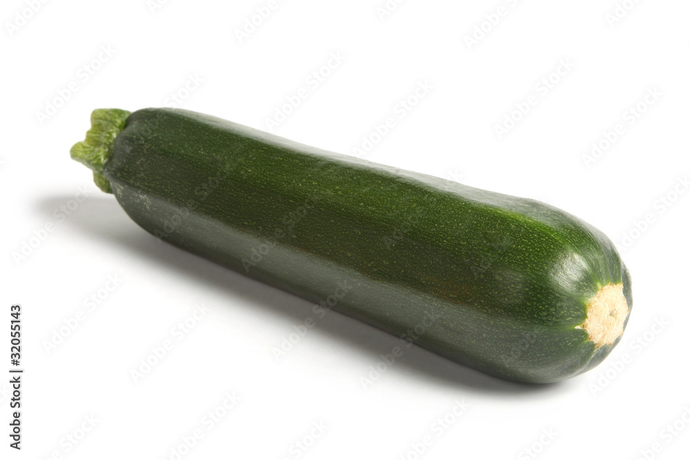 Courgette or zucchini, angled and isolated on white.