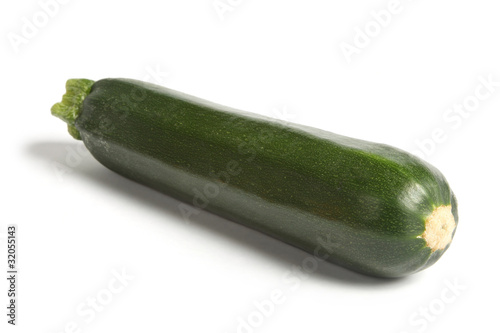 Courgette or zucchini, angled and isolated on white.