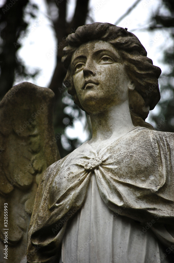 Angel statue in a graveyard at Highgate Cemetery, London