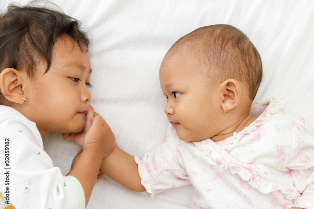 cute little girl and baby playing together cute little girl and baby playing together