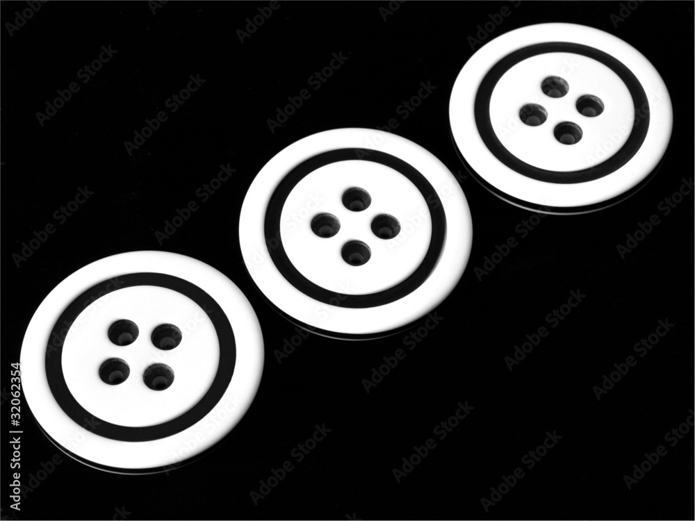 Three black and white buttons on black background Three black and white buttons on black background