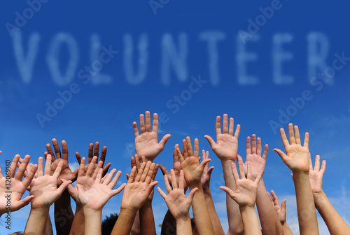volunteer group raising hands