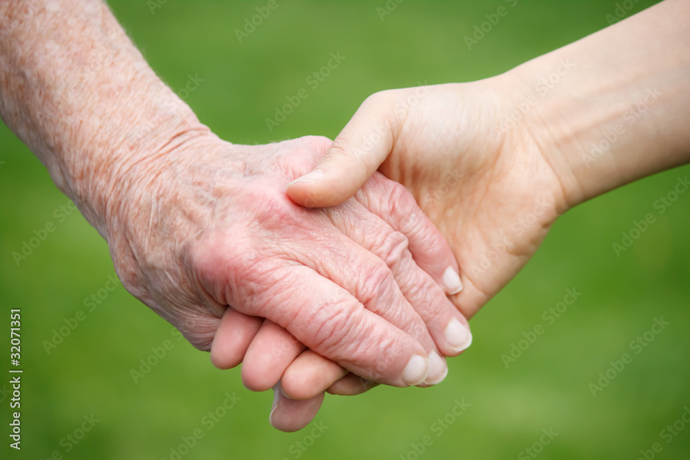 Senior and Young Women Holding Hands Senior and Young Women Holding Hands