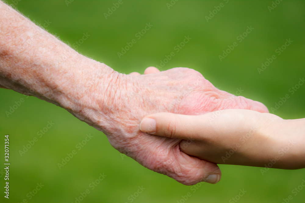 Fototapeta premium Senior and Young Women Holding Hands