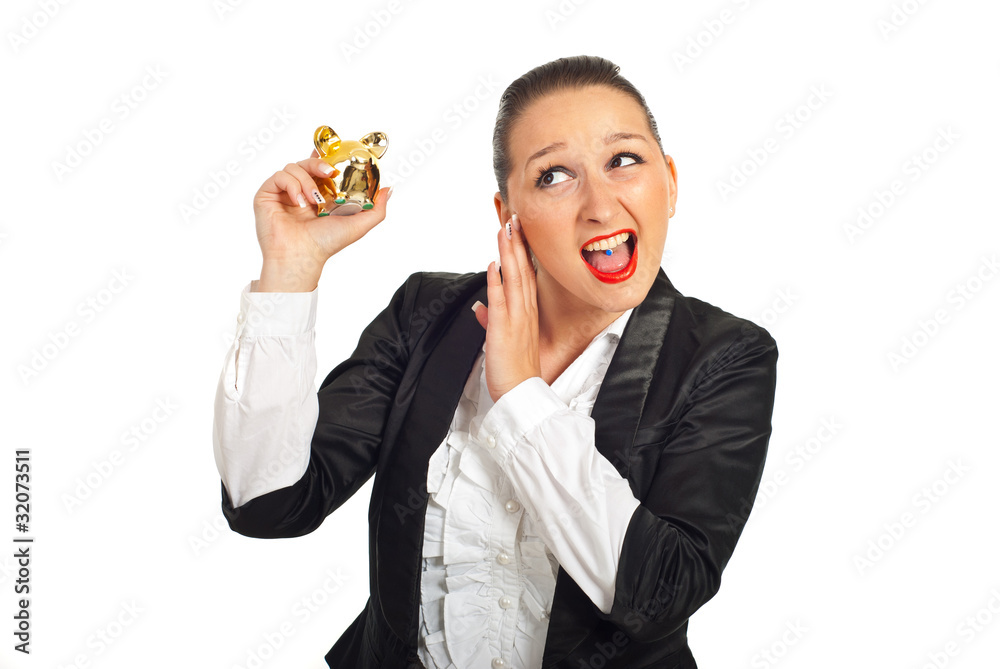 Cool business woman tryind to hear piggy bank Cool business woman tryind to hear piggy bank