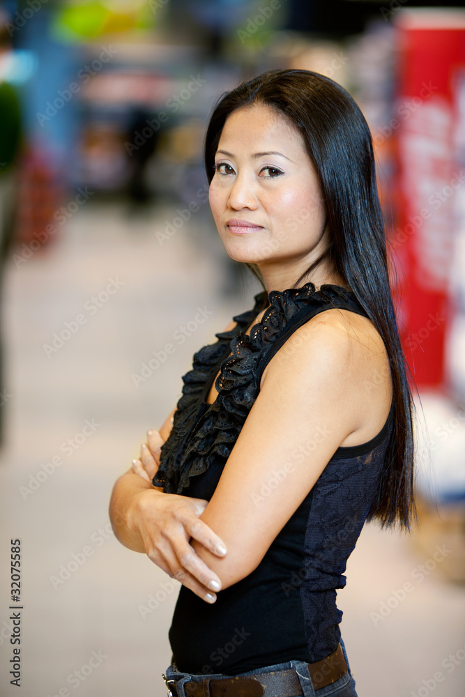 Asian Woman Standing in Supermarket