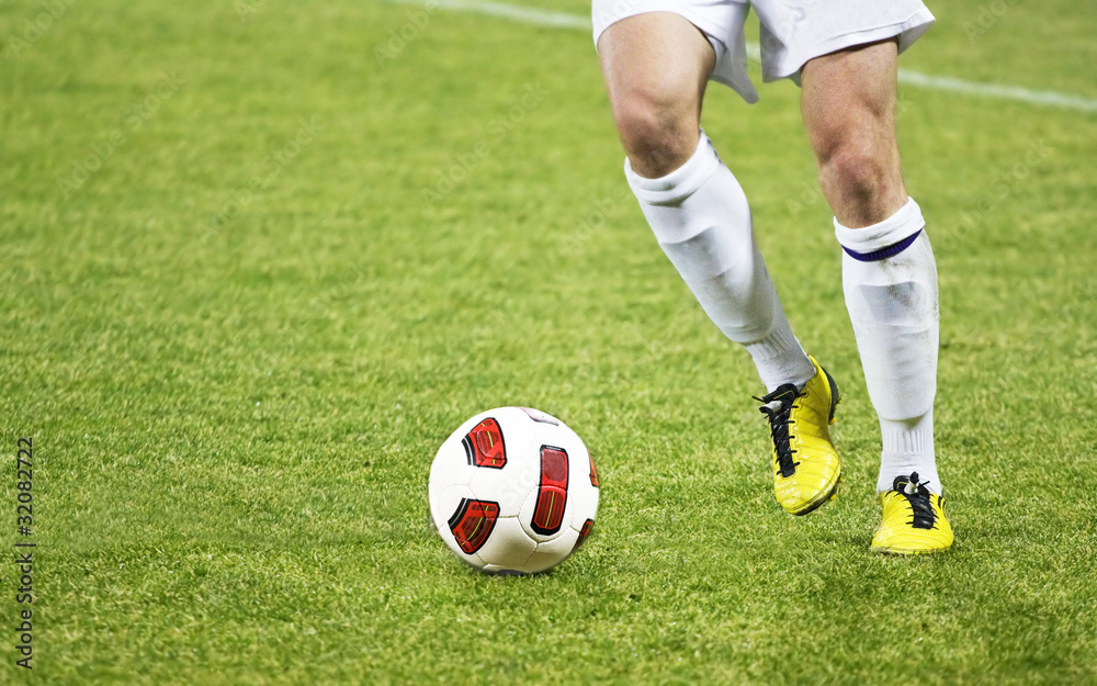 Soccer player running after the ball