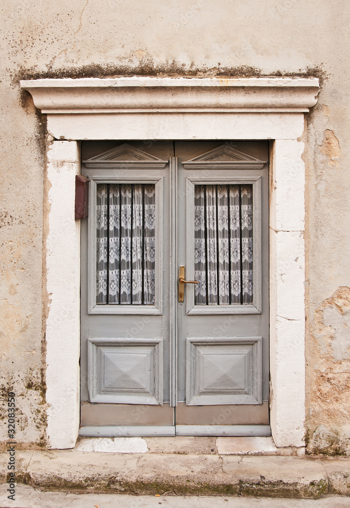 Gray wooden doors in Rijeka, mediterranean town on coast of Croa