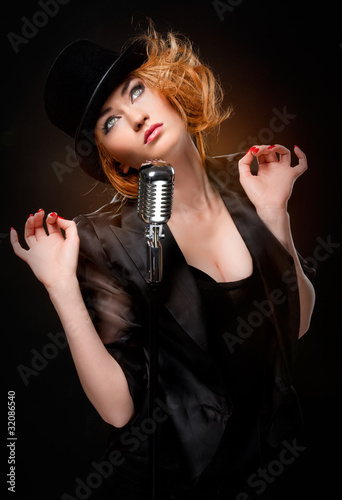 Gorgeous stylish redhead woman with retro microphone © Alex Tihonov