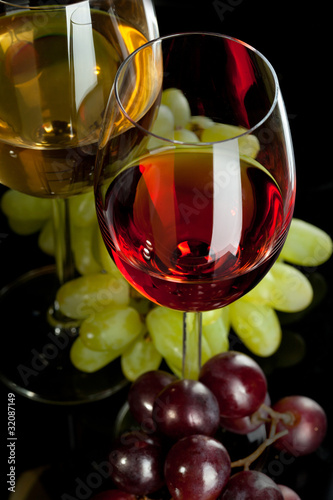 Red and white wine in glasses with grape. Top view