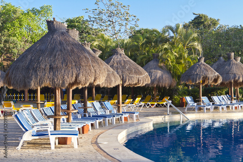 Sunloungers beside a tropical swimming pool