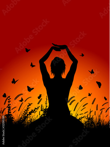 female in yoga pose against sunset sky