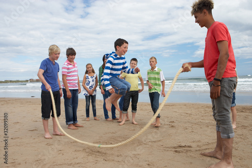 Teenagers playing skipping rope photo