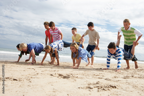 Teenagers playing on beach photo