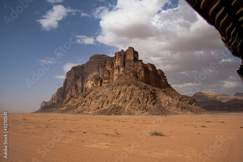 Solitary mountain in middle of the Wadi Rum desert