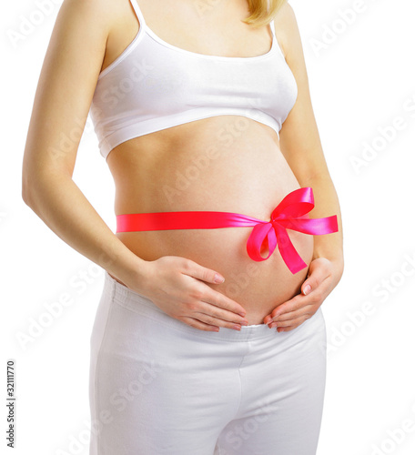 Pregnant woman with pink ribbon on belly isolated on white