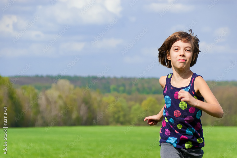 Girl running outdoors on green field Girl running outdoors on green field