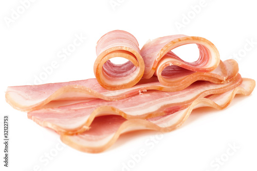 Tasty sliced pork bacon isolated on white background