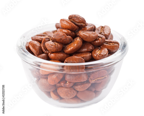 Natural coffee beans heap in transparent glass bowl, isolated on