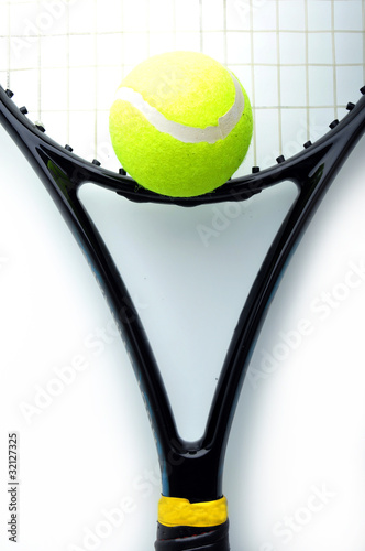 tennis balls on the racket isolated on white background. © anat_tikker