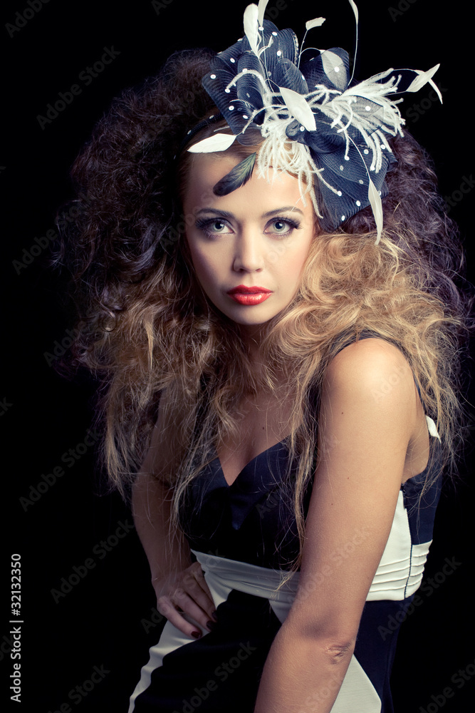 Beautiful young woman wearing fashion hat, isolated on black