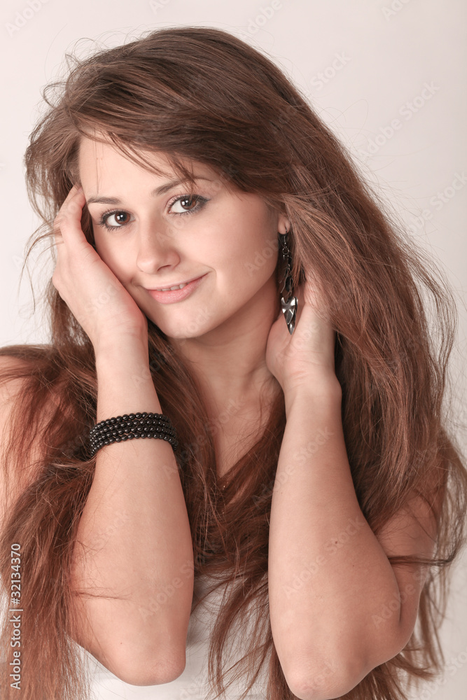 Fototapeta premium Sensual young woman with beautiful long brown hairs