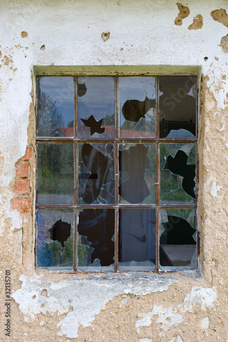 Broken window in a old deserted house photo