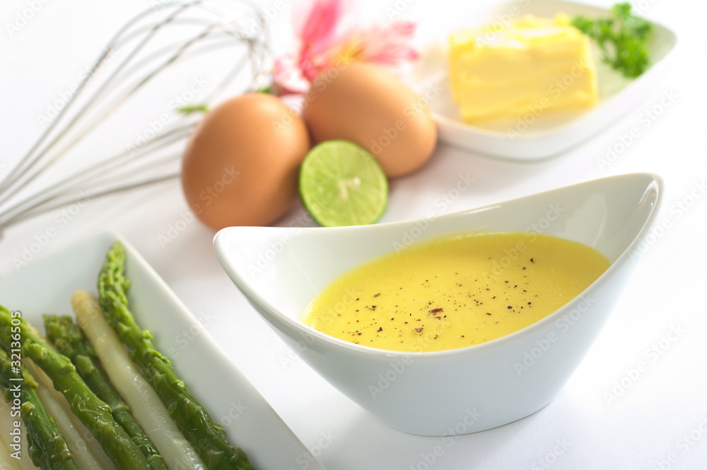 Hollandaise sauce with black pepper and asparagus on the side Hollandaise sauce with black pepper and asparagus on the side