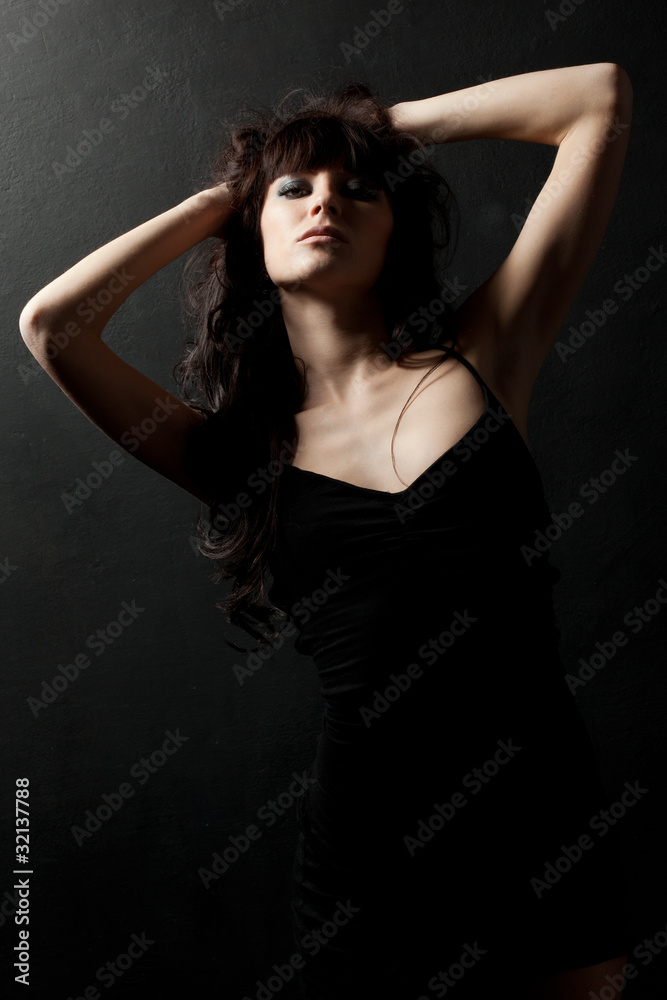woman posing wearing black dress