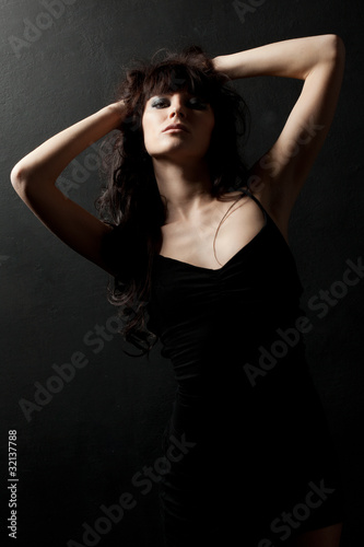 woman posing wearing black dress