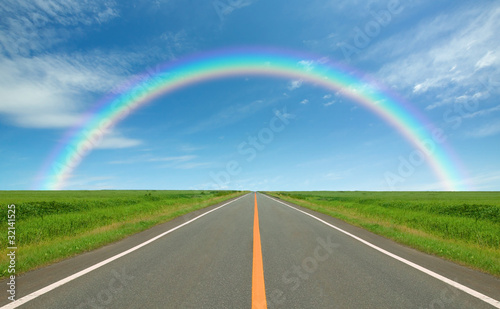 Rainbow over straight road