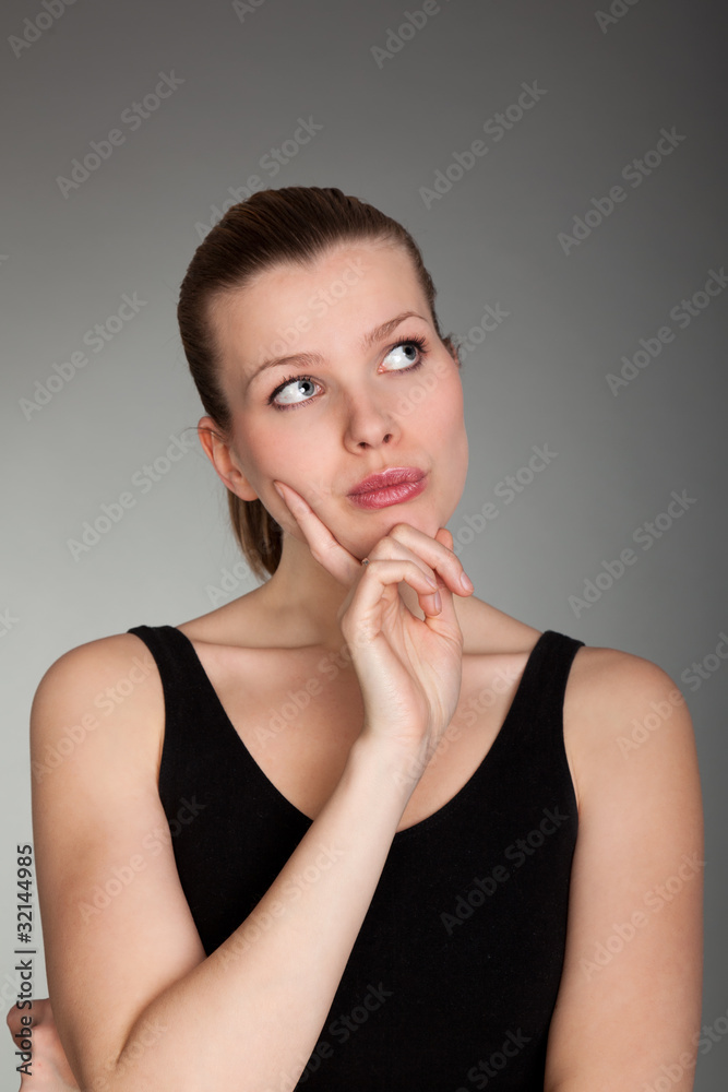 Portrait of a thinkful woman on grey Portrait of a thinkful woman on grey
