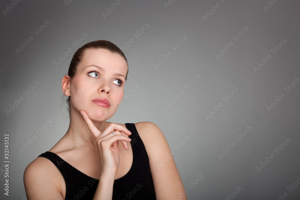 Portrait of a thinkful woman on grey Portrait of a thinkful woman on grey