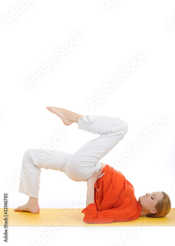 series or yoga photos. young woman doing yoga pose on yellow pil