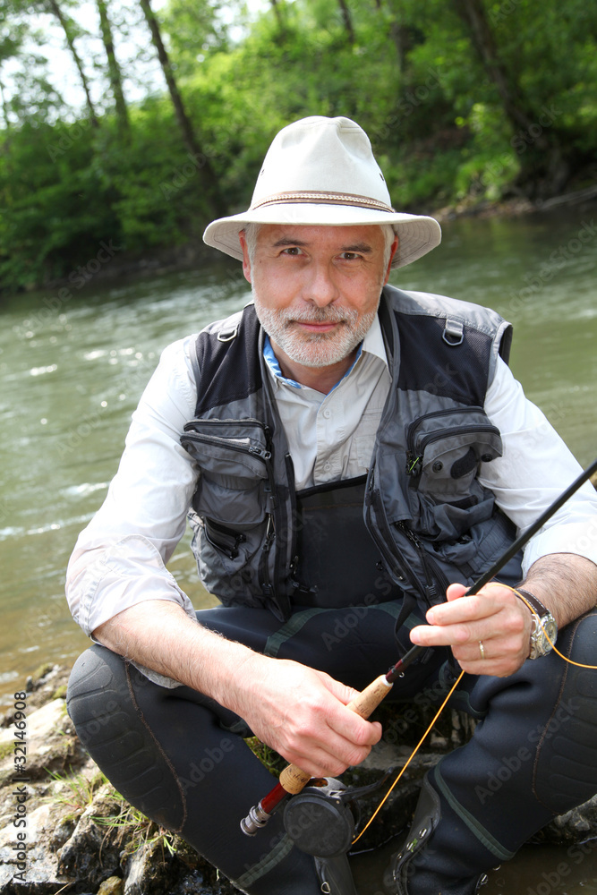 Portrait of fisherman sitting by a river Portrait of fisherman sitting by a river